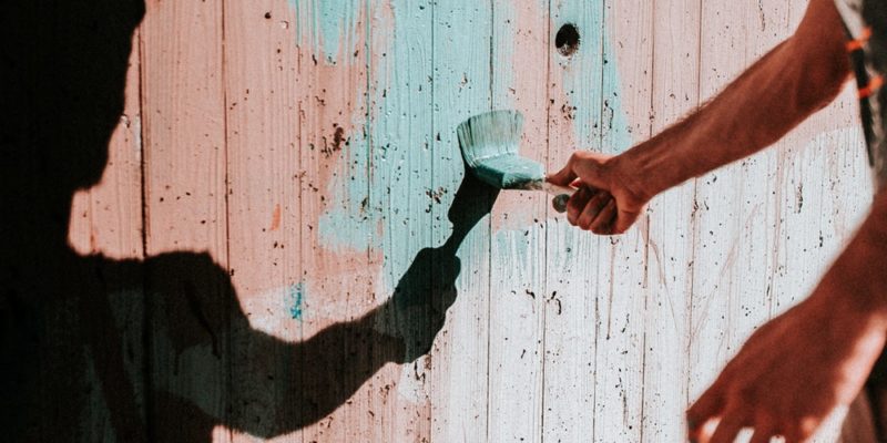 person painting wall