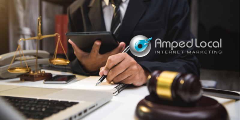 A person in a suit using a computer Description automatically generated